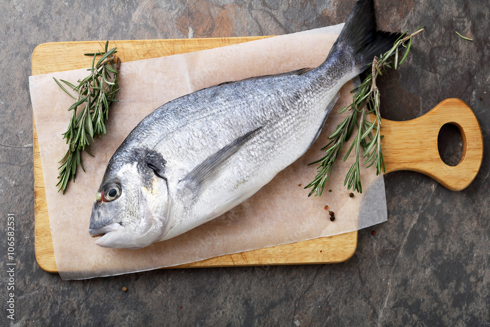 raw fish and herbs on cutting board raw fish and herbs on cutting board