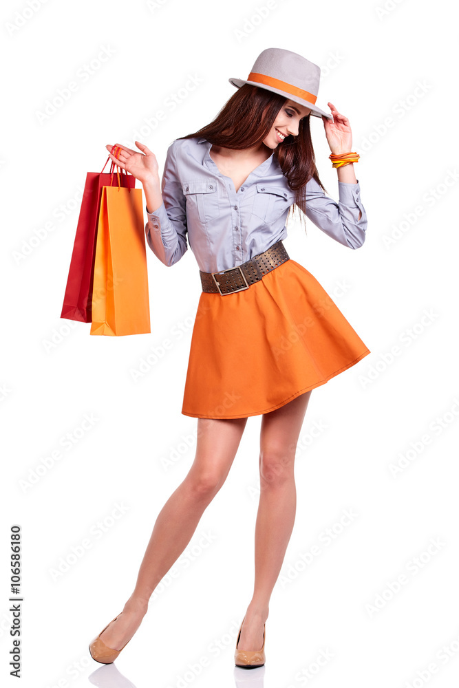 Fashion woman portrait isolated. White background. Happy girl hold shopping bag.
