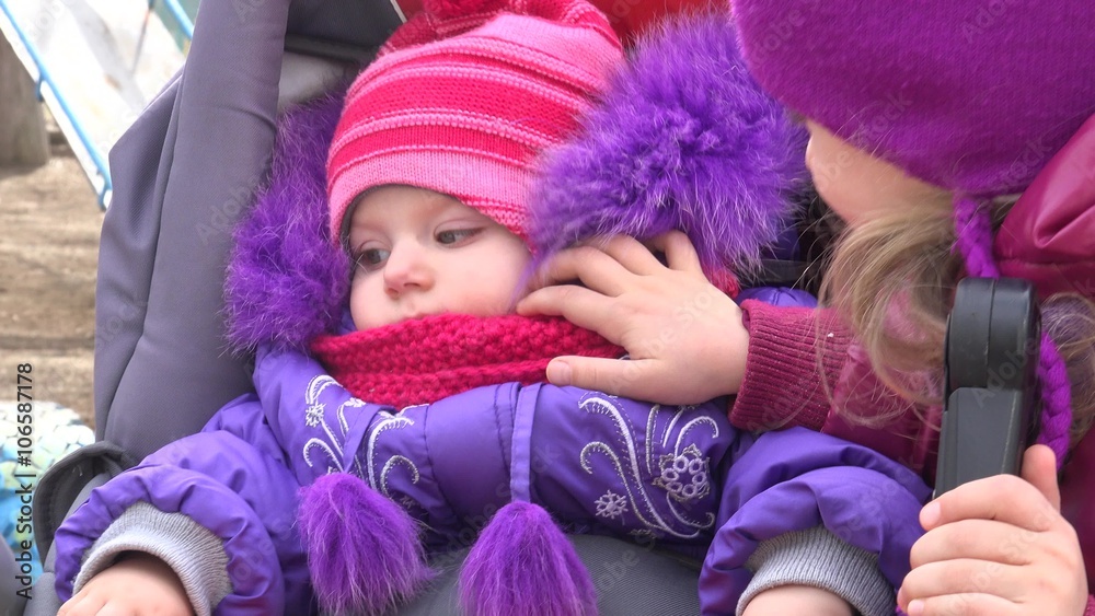 Little Girl Look at her Newborn Sister in Baby Carriage. 4K UltraHD video. Little Girl Look at her Newborn Sister in Baby Carriage. 4K UltraHD video.