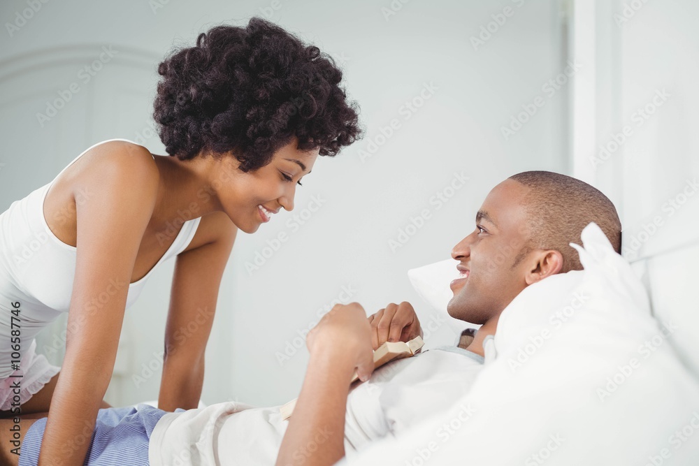 Happy couple reading on the bed Happy couple reading on the bed