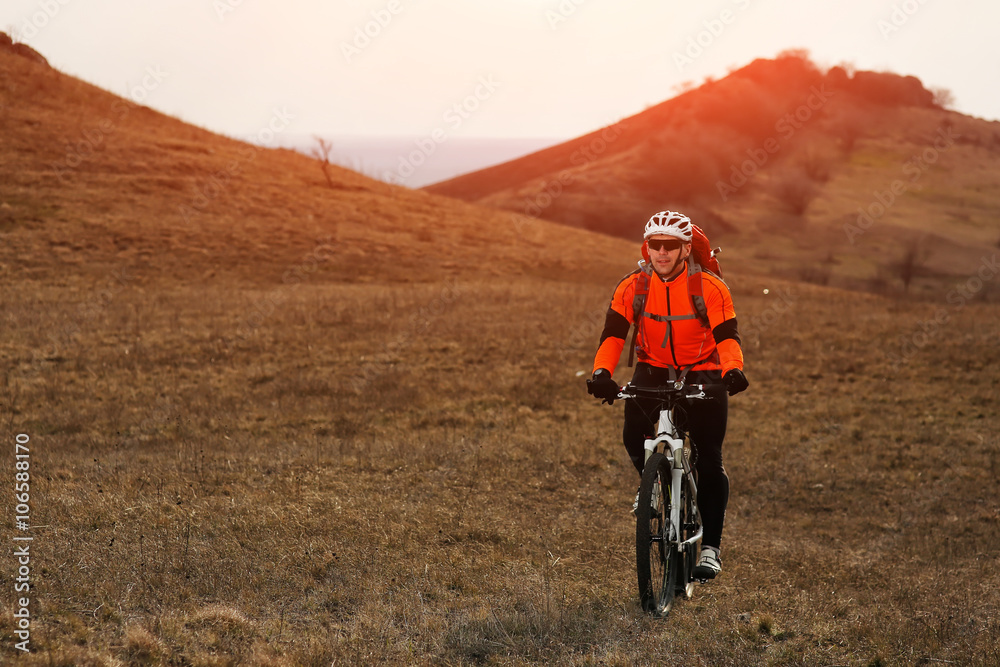 Fototapeta premium Man cyclist with backpack riding the bicycle
