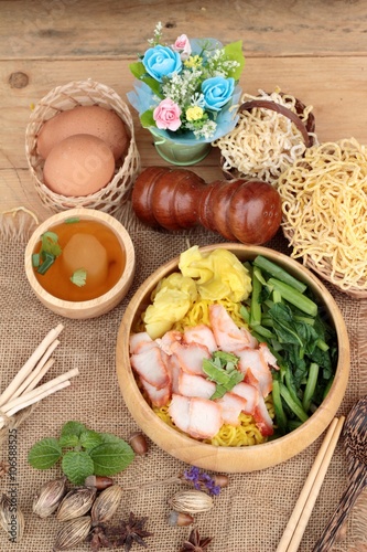 Egg noodles with pork and dumpling in soup.