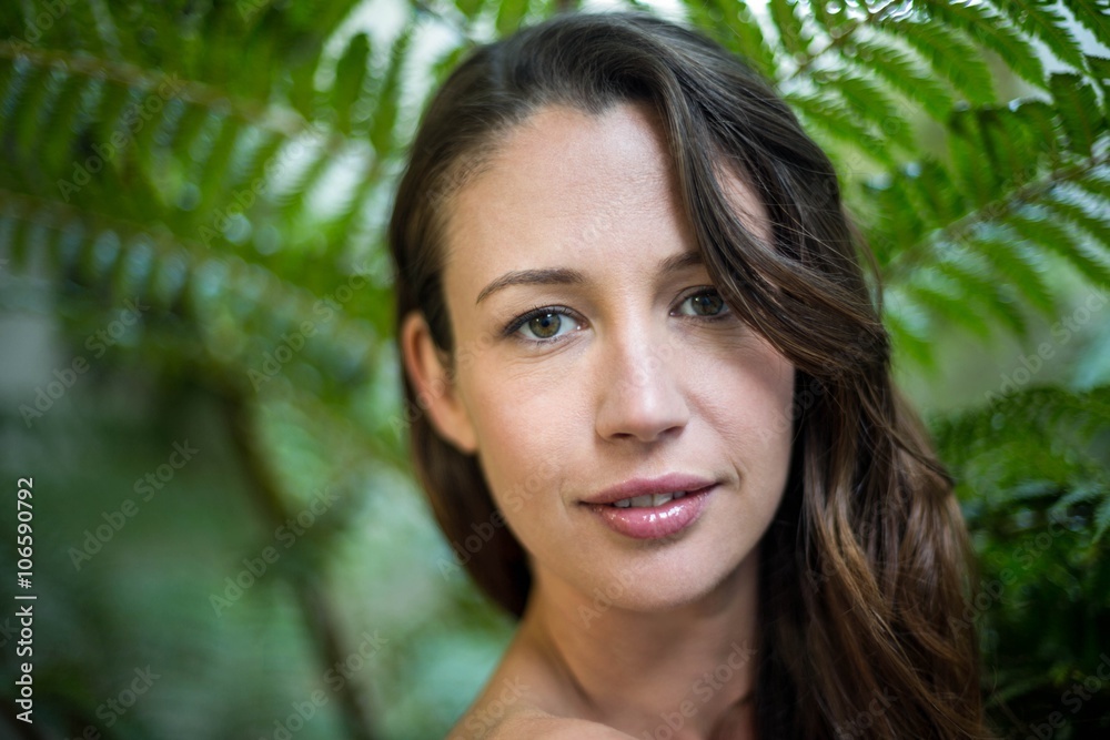 Beautiful woman standing outdoors in garden Beautiful woman standing outdoors in garden