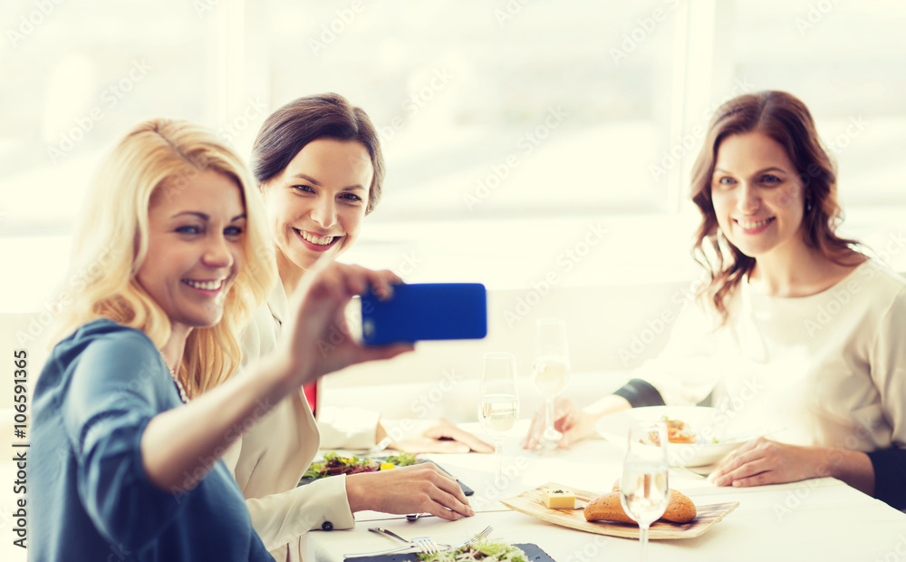 women with smartphone taking selfie at restaurant women with smartphone taking selfie at restaurant