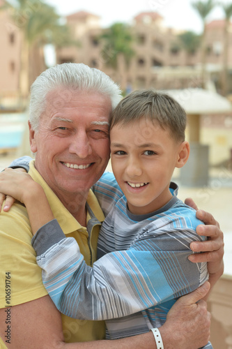 senior man with grandchild at vacation resort