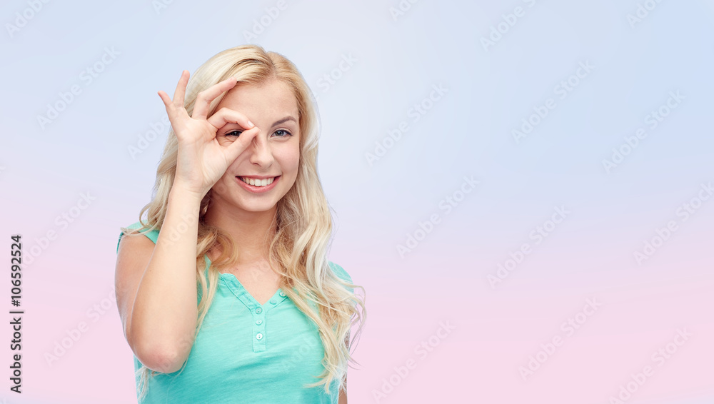 young woman making ok hand gesture