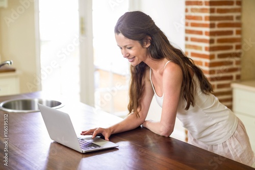 Free Download Happy young woman using laptop - GFXLoad