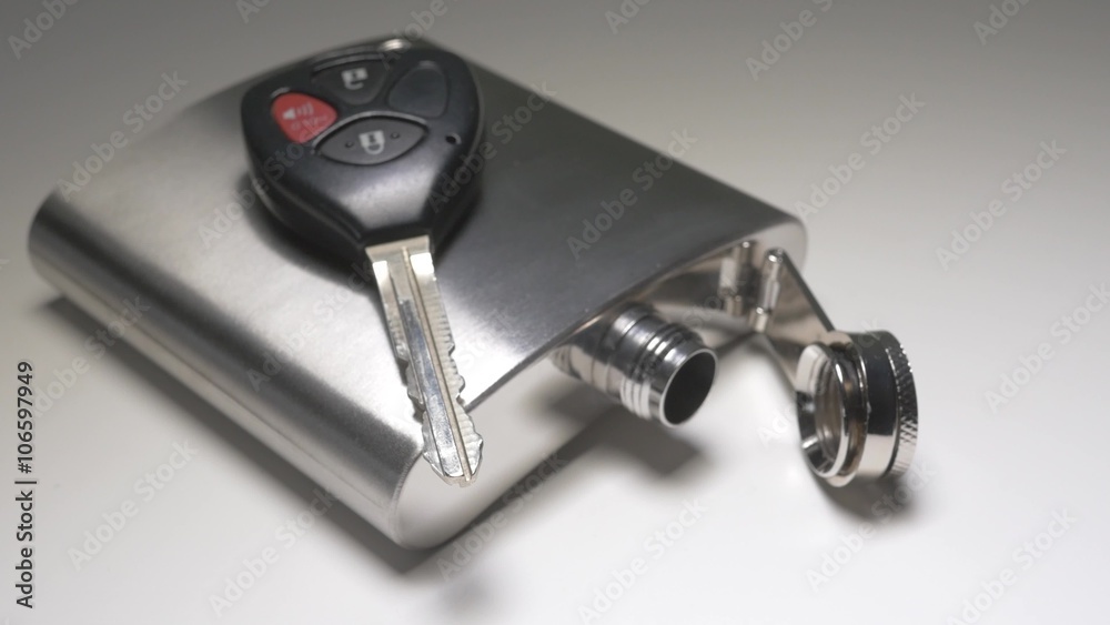Hip flask with a car key on it. Hip flask with a car key on it.