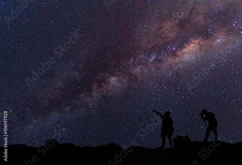 Star-catcher. A person is standing next to the Milky Way galaxy © narathip12