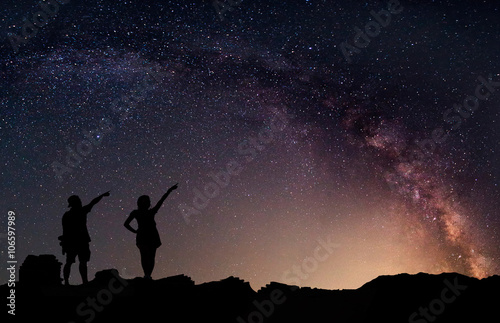 Star-catcher. A person is standing next to the Milky Way galaxy © narathip12