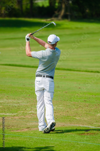 Golfer hitting golf shot.
