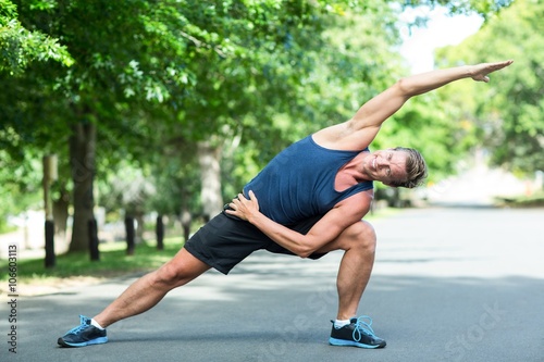 Sportsman stretching in park