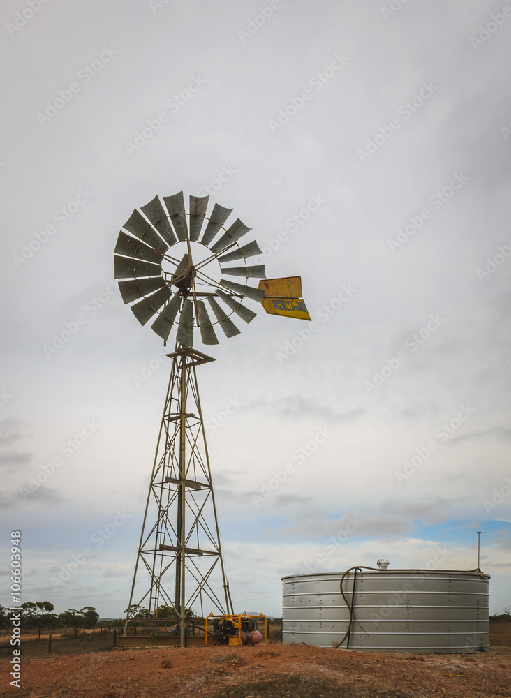 Australian outback old retro wind powered water pump and storag Australian outback old retro wind powered water pump and storag