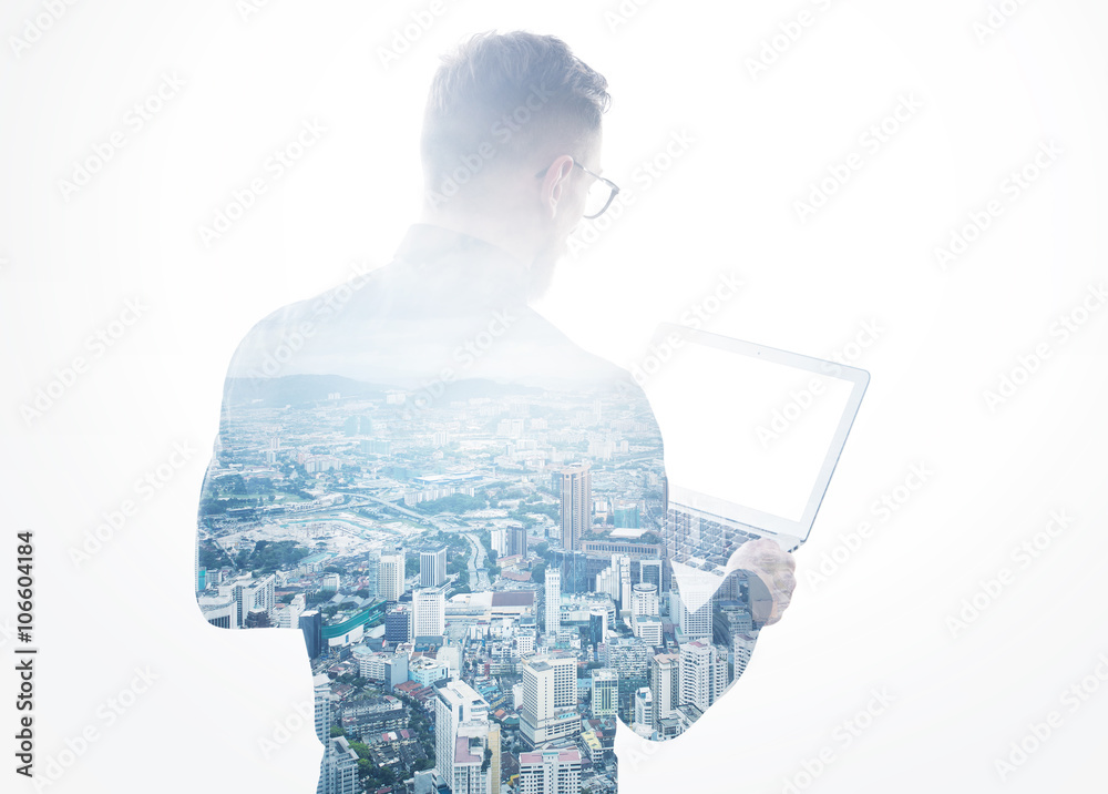 Double exposure young bearded businessman wearing black shirt holding contemporary notebook hands.Isolated white,modern city background.Blank screen ready for your business message.Horizontal mockup 