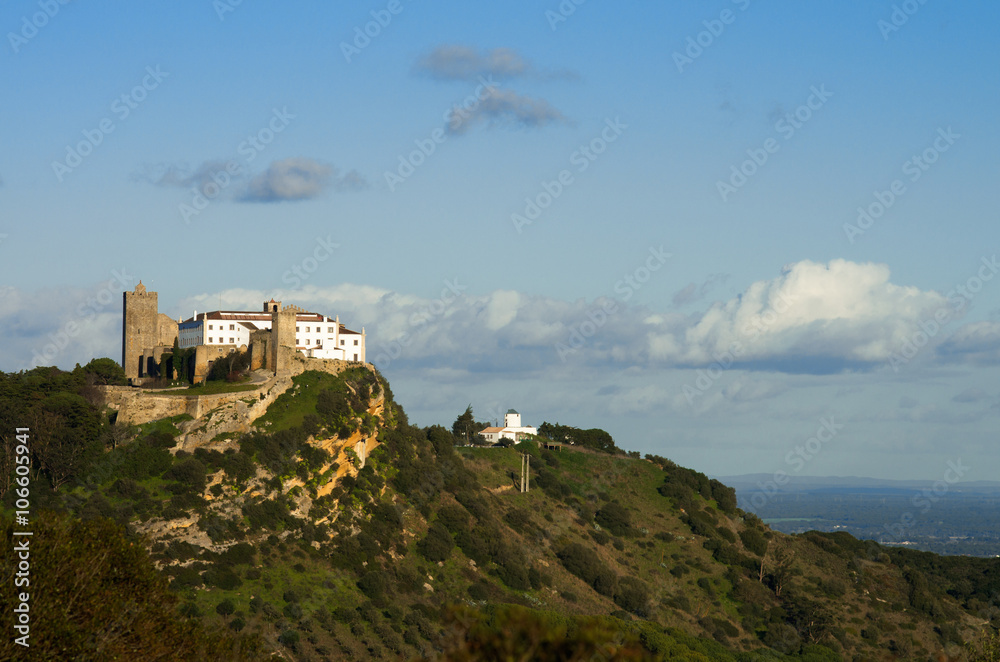 Palmela castle on top of the hill, under blue sky. Portugal
