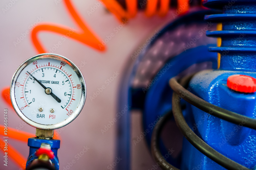Pressure gauge with orange wire and blue pump Stock Photo Adobe Stock