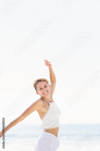Portrait of beautiful woman stretching her arms on the beach © WavebreakMediaMicro