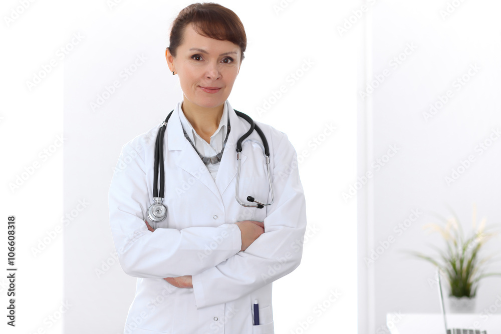 Happy female doctor standing in hospital Happy female doctor standing in hospital