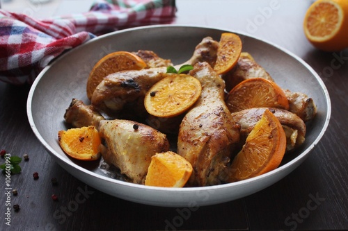 Roasted chicken legs in cast iron skillet, selective focus