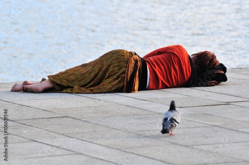 Unrecognizable Woman Sleeping Besides the Sea photo