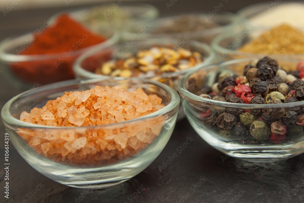 Various kinds of spices in glass bowls on a slate background. Preparation for cooking spicy food. Spices for master cook. The spice trade. Sale of spices in the kitchen.
Various kinds of spices in glass bowls on a slate background. Preparation for cooking spicy food. Spices for master cook. The spice trade. Sale of spices in the kitchen.