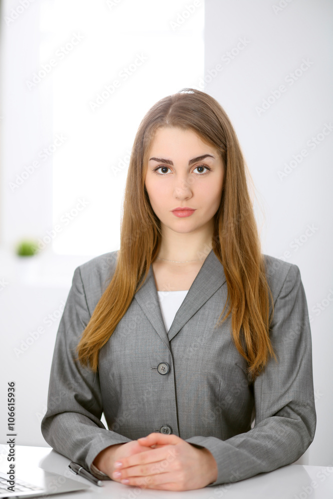 Business lady sitting at the table in office indoors Business lady sitting at the table in office indoors
