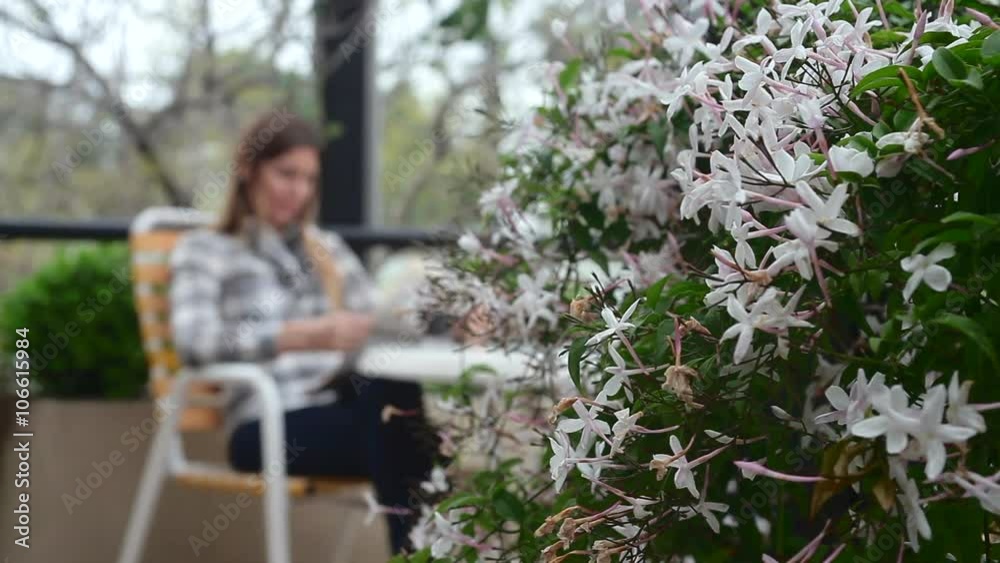 Woman reading the newspaper while she drinks coffee Woman reading the newspaper while she drinks coffee
