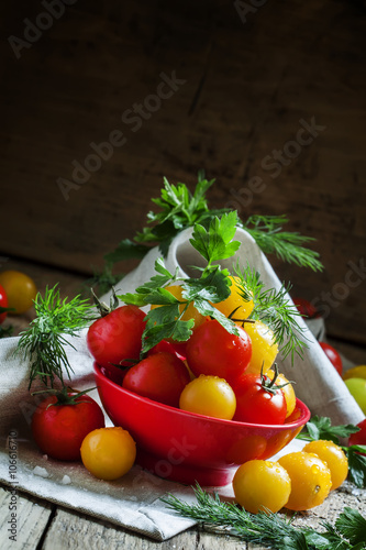Mix red and yellow cherry tomatoes, parsley and dill in red bowl