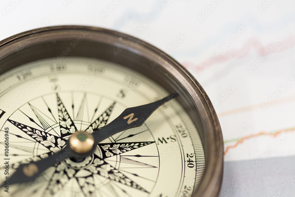 A compass on charts. A direction of success A compass on charts. A direction of success
