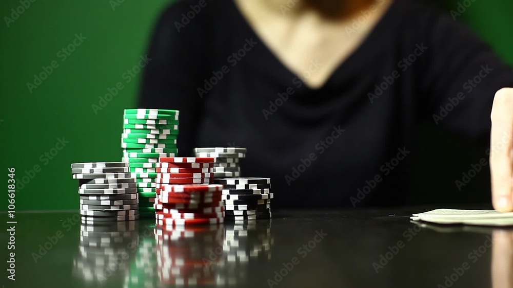 Person pushing some poker chips towards camera.