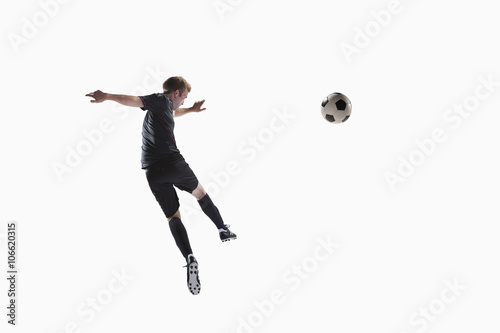 Athlete kicking soccer ball © xixinxing