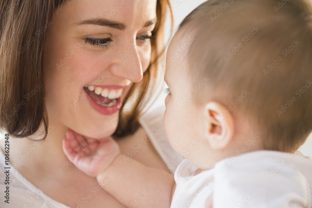Smiling mother playing with baby Smiling mother playing with baby