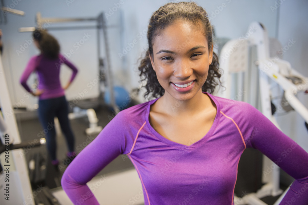 Mixed race woman smiling in gym Mixed race woman smiling in gym