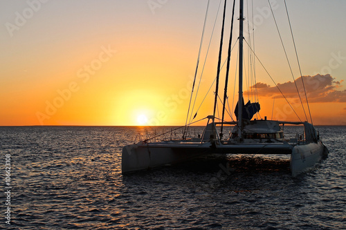 Segelkatamaran im Sonnenuntergang in der Karibik  photo