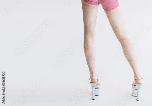 Hairy legs in high heels in pink panties isolated on white background photo