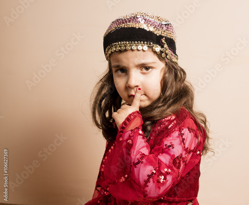 Kurdish girl in red classic kurdish dress in Iraq