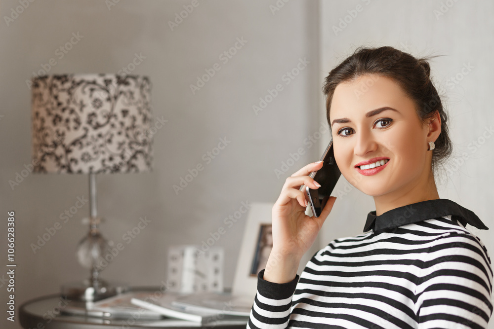 Young bussinesswoman sitting at home and talking with her collegues from work. Young bussinesswoman sitting at home and talking with her collegues from work.