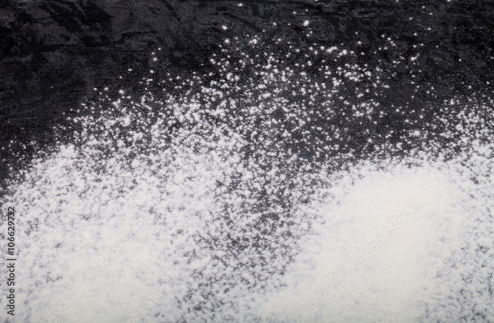 Flour spilling on black background Flour spilling on black background
