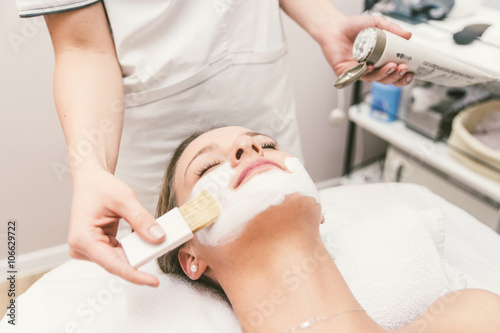 Woman making facial treatment in a beauty saloon
