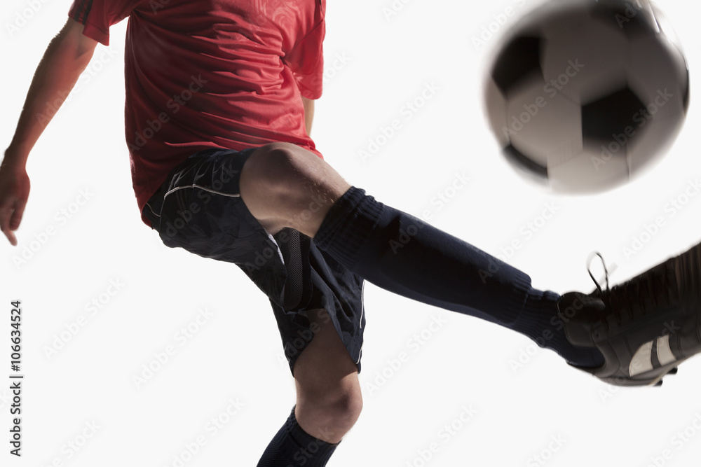 Soccer player kicking soccer ball Soccer player kicking soccer ball