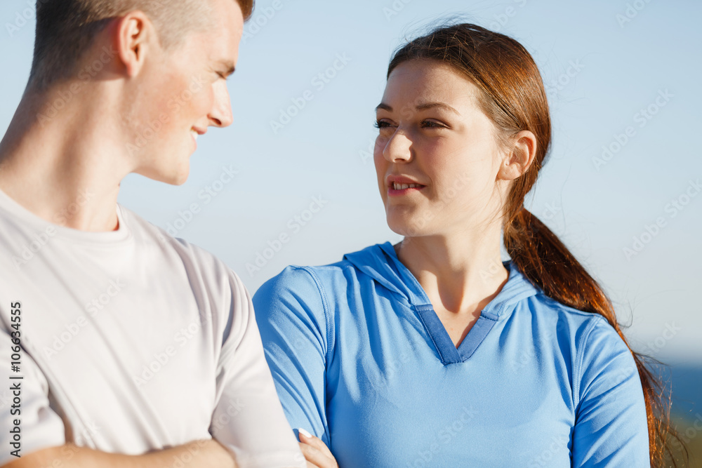 Young couple on beach training together