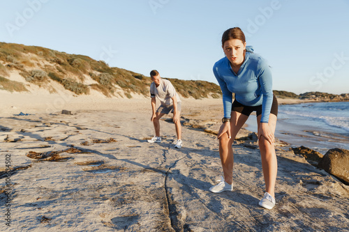 Young couple on beach training together © Sergey Nivens