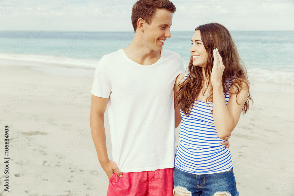 Romantic young couple standing on the beach Romantic young couple standing on the beach
