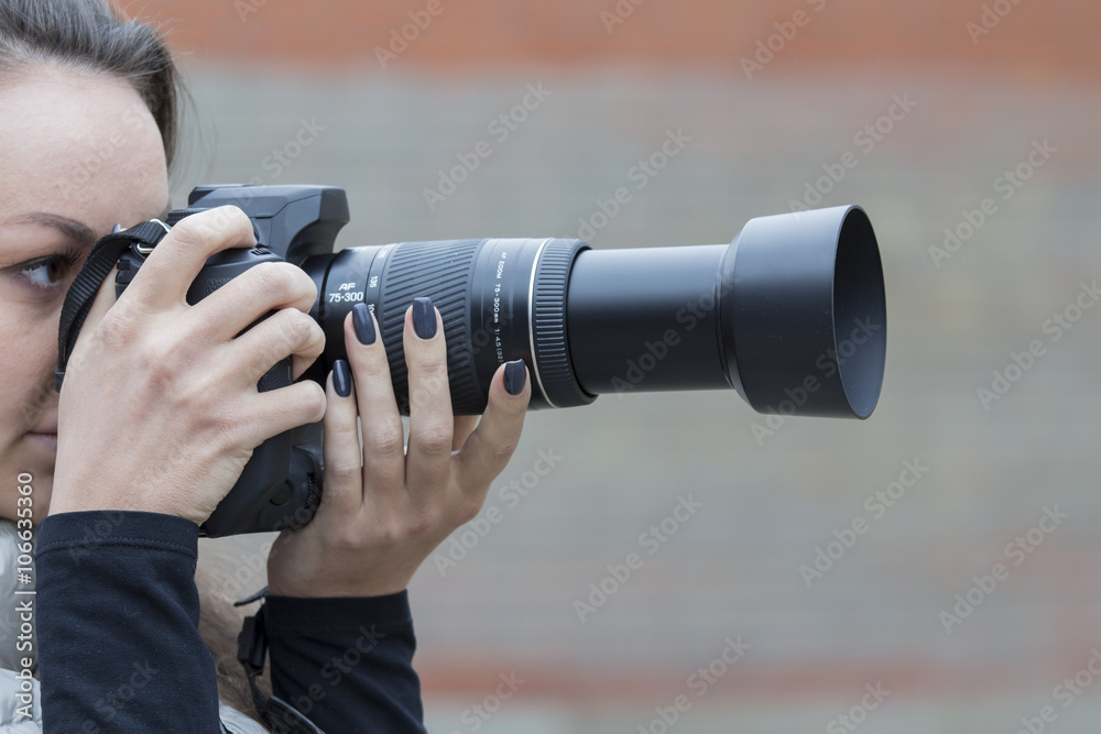 girl with beautiful manicure photographs on single-lens reflex camera girl with beautiful manicure photographs on single-lens reflex camera