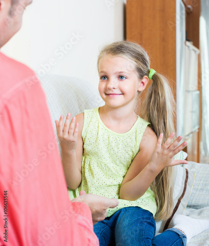 Cute little daughter talking with dad photo