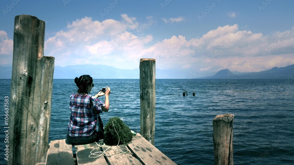 Woman taking photos to the beautiful panorama of Lake Atitlan, Guatemala. 4k Woman taking photos to the beautiful panorama of Lake Atitlan, Guatemala. 4k