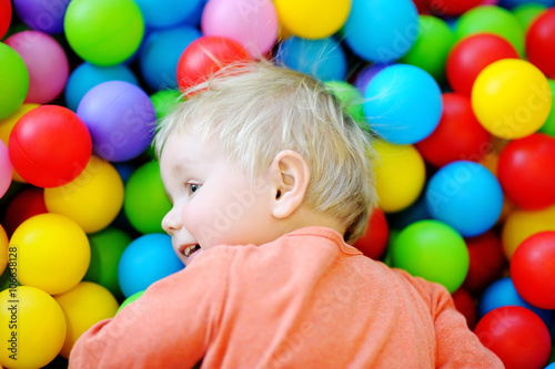 Happy toddler boy in ball pit