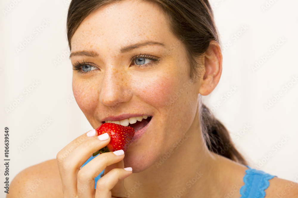 Caucasian woman eating strawberry Caucasian woman eating strawberry