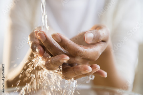 Mixed race woman washing her hands photo