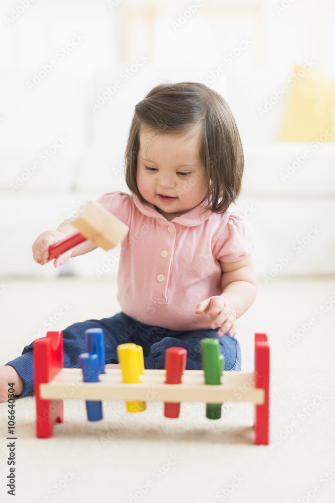 Hispanic toddler with Down syndrome playing Hispanic toddler with Down syndrome playing